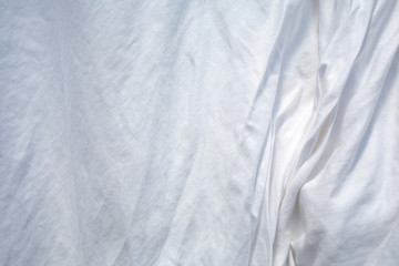 White bedsheet drying in the sun, Wrinkled texture, Abstract background, Close up shot, Selective focus, Housework, Laundry concept