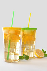 Glasses of tasty cold ice tea on grey background