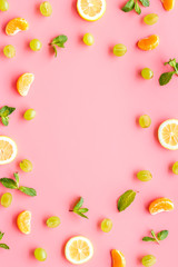 Colorful summer fruits frame on pink background top view copy space