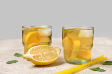 Glasses of tasty cold ice tea on grey background