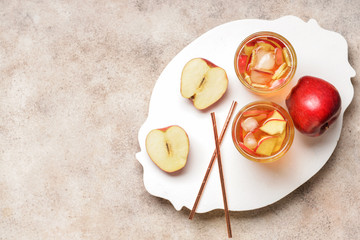 Glasses of tasty cold ice tea on grey background