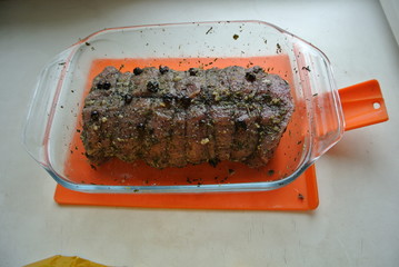 Beef and beef meat in a glass plate. Raw roast beef in spices. Cooking meat marinating in spices and herbs