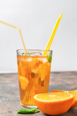 Glass of tasty cold ice tea on table