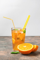 Glass of tasty cold ice tea on table