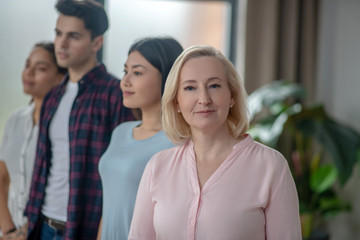 Multi-ethnical group of people standing close to each other