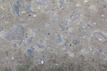 wall of stone. cobblestones. masonry. 
 gray wall. concrete. from small pebbles. interspersed.