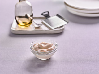 Caesar sauce in a bowl on the kitchen background