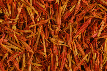 Saffron super macro shot. Fragrant spice saffron background. Texture of red and orange saffron. Stigmas of crocus flower.