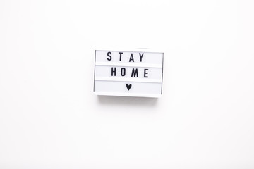 Stay home lettering on box on white isolated background.