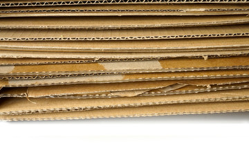 Close-up of stacked corrugated cardboard on white background.
