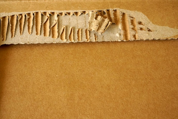 Close-up of stacked corrugated cardboard. Sheets of brown corrugated cardboard.