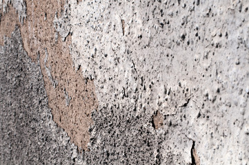 side view to an old wall with weathered plaster