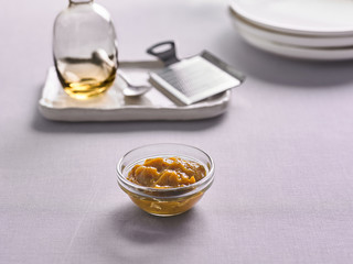 mustard sauce in a bowl on the kitchen background