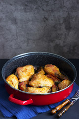 Baked chicken with apples in a deep pan.