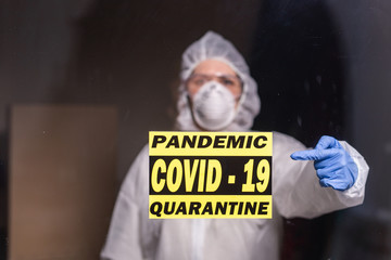 Woman in protective white overalls, mask and glasses on his face. Coronavirus, pandemic, covid-19, flu and quarantine concept.