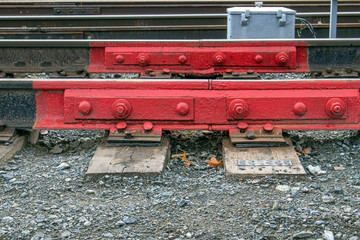 Railway rails docked together and fixed. This part is painted red.