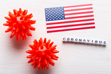 Covid-19, pandemic, quarantine and virus concept - coronavirus cells with american usa flag on white background.