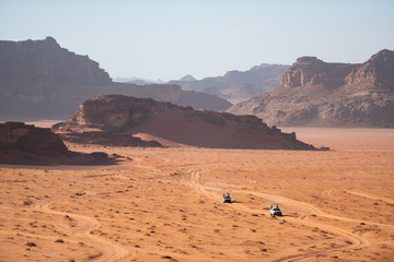 Fototapeta na wymiar Two Jeeps in wadi rum desert, Jordan.