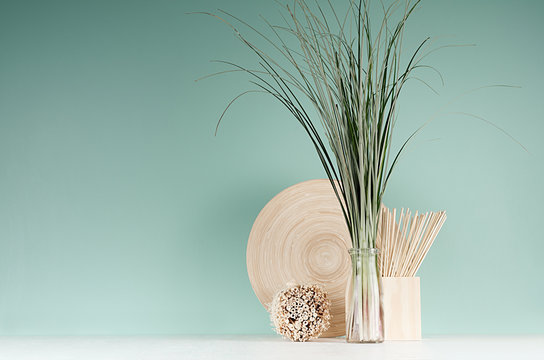 Minimalist Cozy Interior With Beige Natural Organic Home Decor - Bamboo Plate, Bouquet Of Herb In Bottle, Round Sheaf Of Twigs On Mint Menthe Wall, White Wood Board.