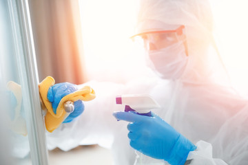 Disinfection and cleaning door handles of house from infection with virus and microbes in...