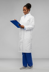 medicine, profession and healthcare concept - smiling african american female doctor or scientist...