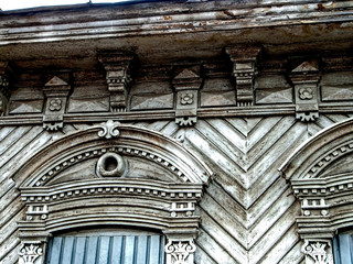 Details of the Carved wooden facade of the old house. House with carved wooden architraves, Russia,...