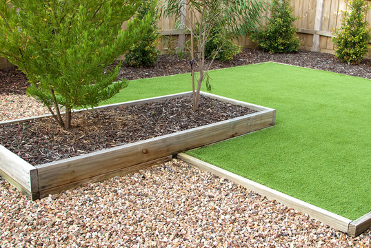 Combination of timber, plants, artificial grass, decorative gravel and mulch