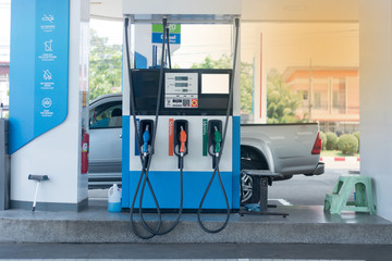 Gas stations filling cars for cars during times of economic downturn and oil prices dropped significantly.