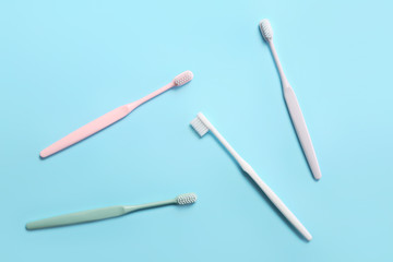 Tooth brushes on color background