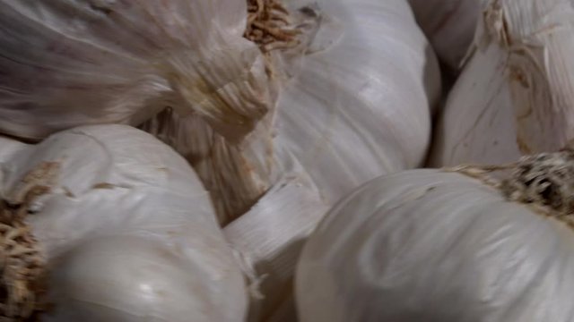 Close up of garlic bulbs with skins on 4K