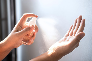 Women washing hands with alcohol spray clean hands hygiene prevention and disinfection of...