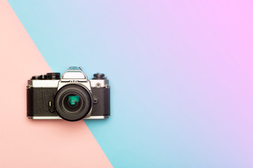 Photo camera creative concept background. Vintage retro photo camera on a colored background. Travel, vacation and photography concept