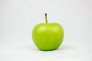 Single green apple with white background