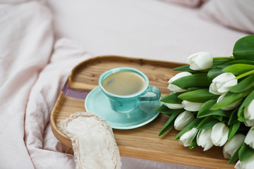 Romantic morning.A coffee table in a pink bed, a Cup of coffee and flowers on the table. Valentine's day