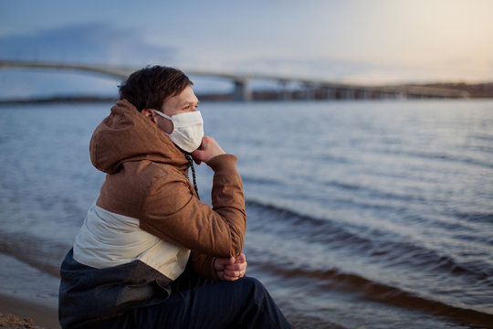 Walk alone during the coronavirus in nature away from people to keep their distance. Health Care Movement During Pandemic Covid 19 isolation. Outside the city outside is fresh air. Medical face Protec