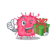 Smiling pathogenic bacteria cartoon character having a green gift box