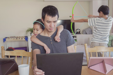 stressed father working from home with children. Homeschooling, stay home, social distancing during...
