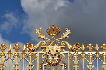 Fototapeta na wymiar Elements of golden gates decorations at Versailles in Paris, France