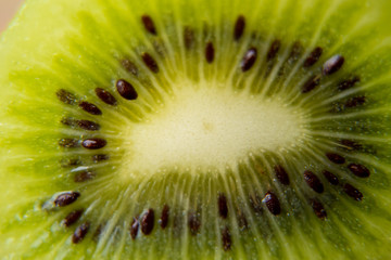 Close-up of slice of ripe kiwi. fruit gives off freshness and juice. fruit for diet and healthy food concept