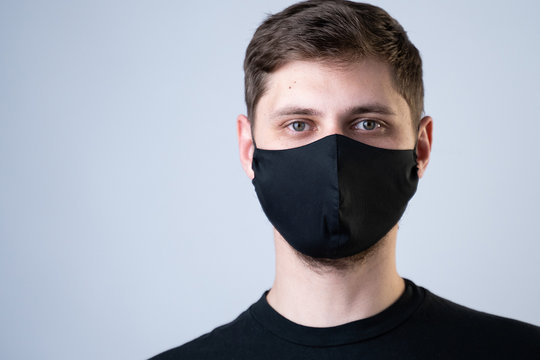 Young Man Wearing Black Face Mask. Pandemic Coronavirus Covid-19 Quarantine Period Concept.