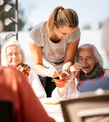 Young woman having social activities with senior people