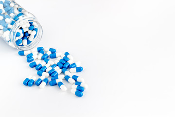 Creatine capsules. Pills scattered on white background copy space