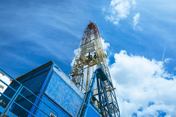 Oil drilling rig on a background of blue sky