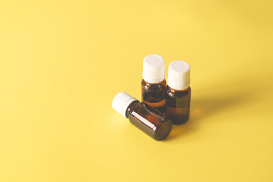 three glass bottles on a yellow background