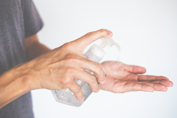 Man hands using wash hand sanitizer gel dispenser, against Novel coronavirus or Corona Virus Disease (Covid-19)  Hygiene and Healthcare concept
