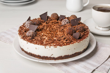 Tasty chocolate cheesecake on table