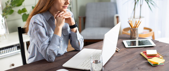 Businesswoman working with laptop at home