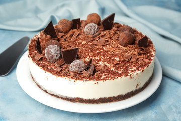 Tasty chocolate cheesecake on color background