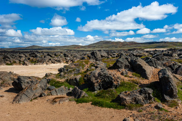 Beautiful colourful Icelandic landscape lava fields mountain geysers zigzag road and moss-covered...