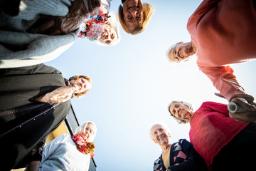 Obraz premium Mature people in circle with hands for unity and friendship
